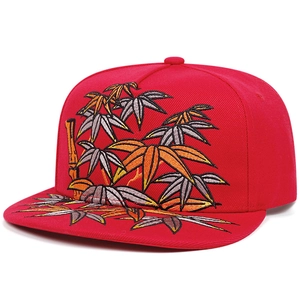 Detail showing high-density bamboo embroidery on a red flat-brim snapback hip hop hat