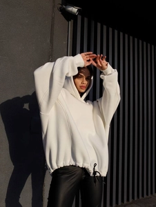 Oversized white drawstring hoodie featuring drop shoulders and a street style outdoor look