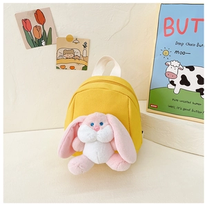 Detailed shot of kids yellow canvas backpack with cute pink plush bunny rabbit character