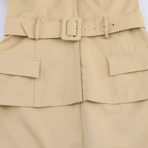 Detail of khaki cotton dress waist with matching belt, square buckle and flap pockets