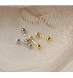 Detailed view of mini pearl screw back earrings in gold and silver on soft mesh fabric
