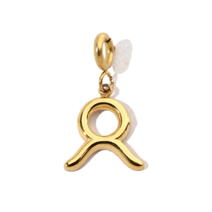 Macro detail of a 18K gold plated stainless steel Taurus zodiac sign pendant