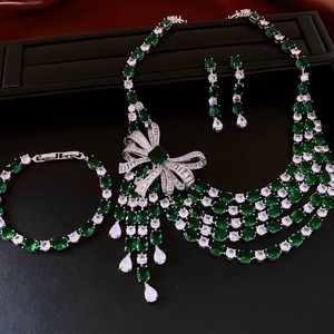 Luxurious emerald and white zircon jewelry set featuring a bow necklace and tassel earrings