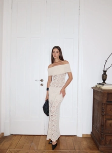 Close-up of off-white off-shoulder crochet maxi dress with hollow diamond knit texture