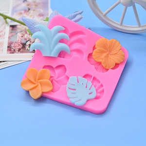 Pink silicone mold featuring tropical monstera leaf and hibiscus flower shapes for fondant