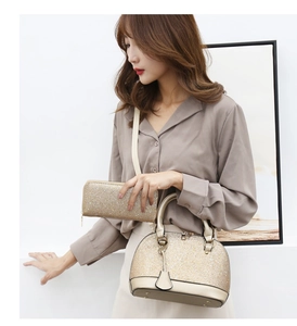 Detailed view of women's gold sequin shell handbag and matching wallet worn by a model