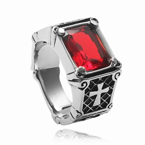 Detail view of vintage steel ring with red stone and embossed side cross pattern