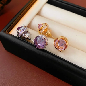 Macro view of 18k gold plated stud earrings with purple and orange zircon stones