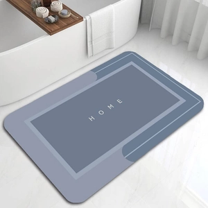 Detail view of Morandi blue absorbent bath mat with HOME text in a modern bathroom