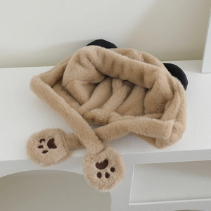 Détail d'un bonnet panda en peluche marron avec oreilles et pattes sur support blanc