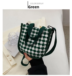 Detail of green and white houndstooth knit mini bag with matching handles and long strap
