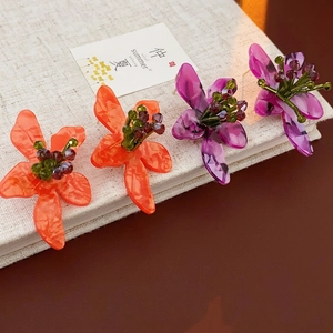 Vintage flower earrings with orange and purple acrylic petals and beaded centers