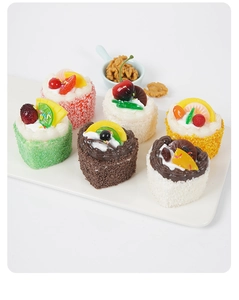 Close-up of artificial heart mousse cake magnets with cream texture and peanut bits