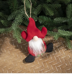 Detail of a handmade Christmas gnome ornament with red felt hat and white beard hanging