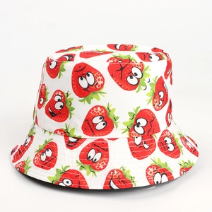 Detailed view of white bucket hat with creative cartoon strawberry prints and fine stitching