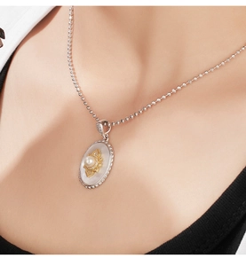 Macro detail of 925 sterling silver necklace with pearl mother-of-pearl lotus pendant