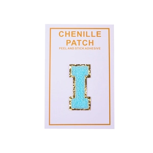 Detail of light blue chenille letter I patch with gold glitter border and adhesive back