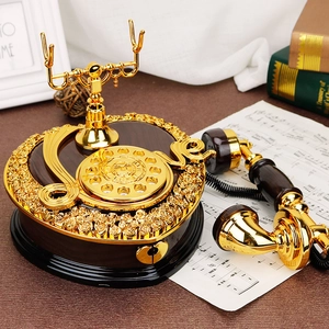 Vintage rotary phone music box with heart base and golden rose embossing in retro setting