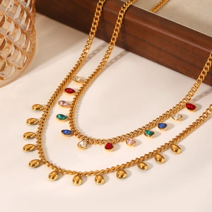 Gold chain necklace with colorful zircon tassel charms and water drop pendants on white background