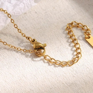 Detail of 18K gold plated lobster clasp and extender chain on a moon star necklace