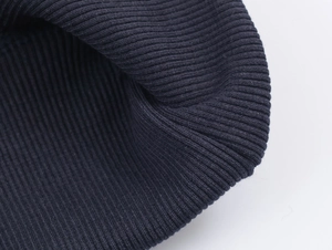 Detailed close-up of dark blue ribbed knit fabric on a casual pullover sweatshirt