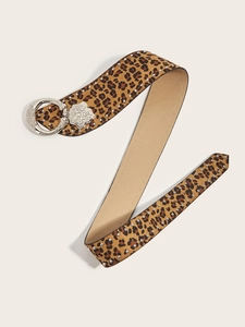 Macro detail of leopard print belt with silver studs and an ornate carved buckle