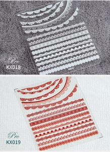 Detailed macro view of white and red lace embossed 5D nail art stickers KX018 KX019