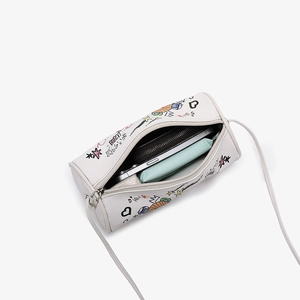 White cylinder crossbody bag with graffiti bear print showing internal storage capacity