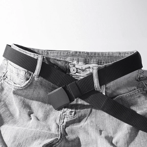 Tactical black nylon belt with plastic buckle on jeans for outdoor and training use