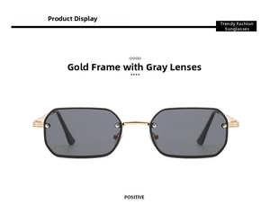 Close-up of rimless ocean lens sunglasses with gold metal frame and gray lenses
