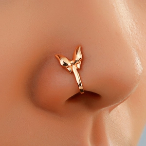 Macro detail of rose gold butterfly nose clip with zircons on model nose