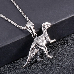 Detailed close-up of a silver stainless steel dinosaur pendant with textured engraving