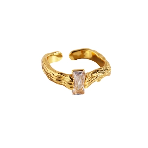 Lava texture gold open ring with emerald-cut cubic zirconia in a minimalist style