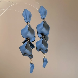 Detailed close-up of navy blue acrylic petal tassel earrings with elegant matte finish