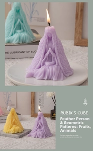 Detail of artistic feather cloak candle figures in purple, yellow and green colors