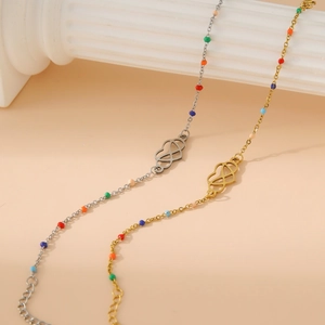 18k gold heart Mobius bracelet with colorful beads and interlocking heart charms