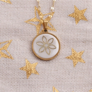 Detail of gold starfish shell flower pendant with mother of pearl inlay on gold chain