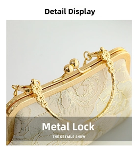 Detail of elegant floral embroidery and gold-tone bead clasp on a vintage evening clutch bag