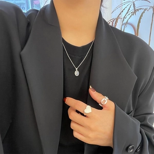 Detailed view of a 925 silver opal pendant necklace with matching minimalist rings