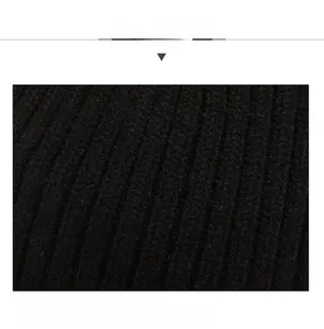 Close-up of the vertical ribbed knit fabric and thick texture on a black winter beanie