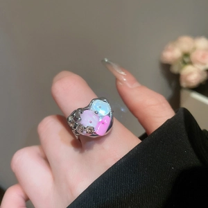Detail of irregular silver heart ring with pink and blue shell beads and small diamonds