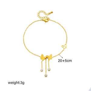 Gold butterfly anklet with sparkling tassels and clear rhinestones on a white background
