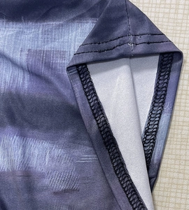 Macro detail of high-quality double-needle hem stitching on floral print mini dress