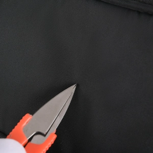Macro shot of durable black water-resistant nylon fabric with anti-scratch test