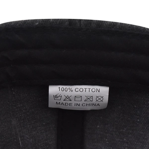 Detail of internal wash care label showing 100% cotton fabric on dark baseball cap
