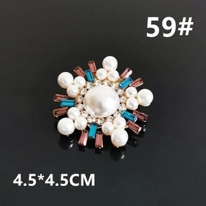 Detailed snowflake brooch with pearls and blue crystals measuring 4.5 by 4.5 cm