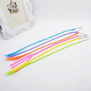 Close-up of five colorful braided hair extensions with metal clips for kids' hairstyles