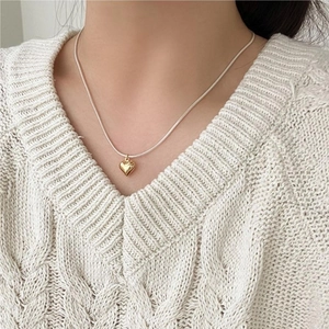 S925 sterling silver snake chain necklace with a 3D gold heart pendant on a model
