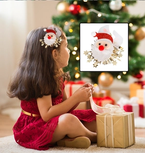 Detail of a Santa Claus hair clip with mesh wings, tassels and stars for Christmas decor