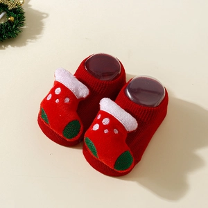 Detail of red Christmas baby socks with 3D sock-shaped ornaments and non-slip knit texture